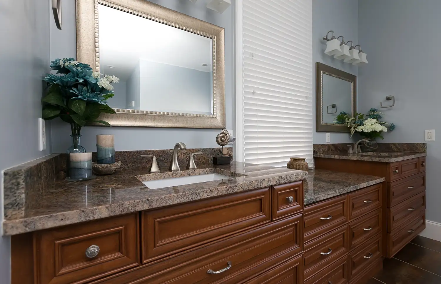 Bathroom vanity with double sinks and granite countertop.
