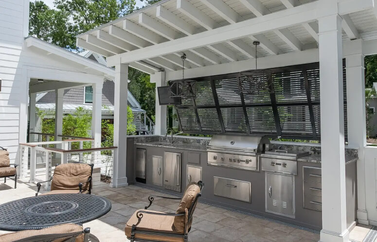 Outdoor kitchen with stainless steel appliances and granite counters